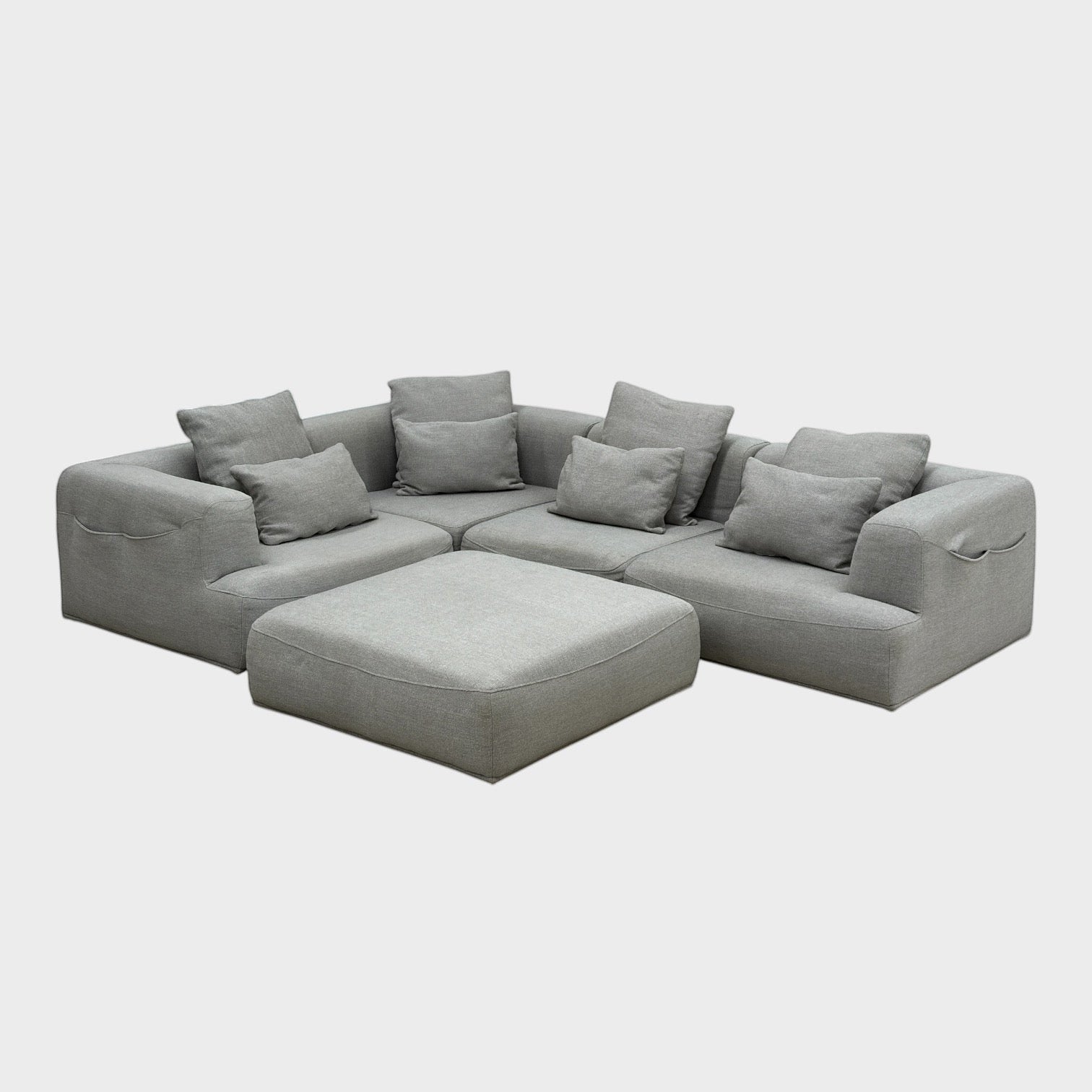 Rehomed Sabine modular grey poly-blend couch with deep seating and curved top-stitching. Includes 5 pieces and ottoman.