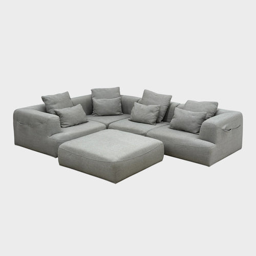 Rehomed Sabine modular grey poly-blend couch with deep seating and curved top-stitching. Includes 5 pieces and ottoman.